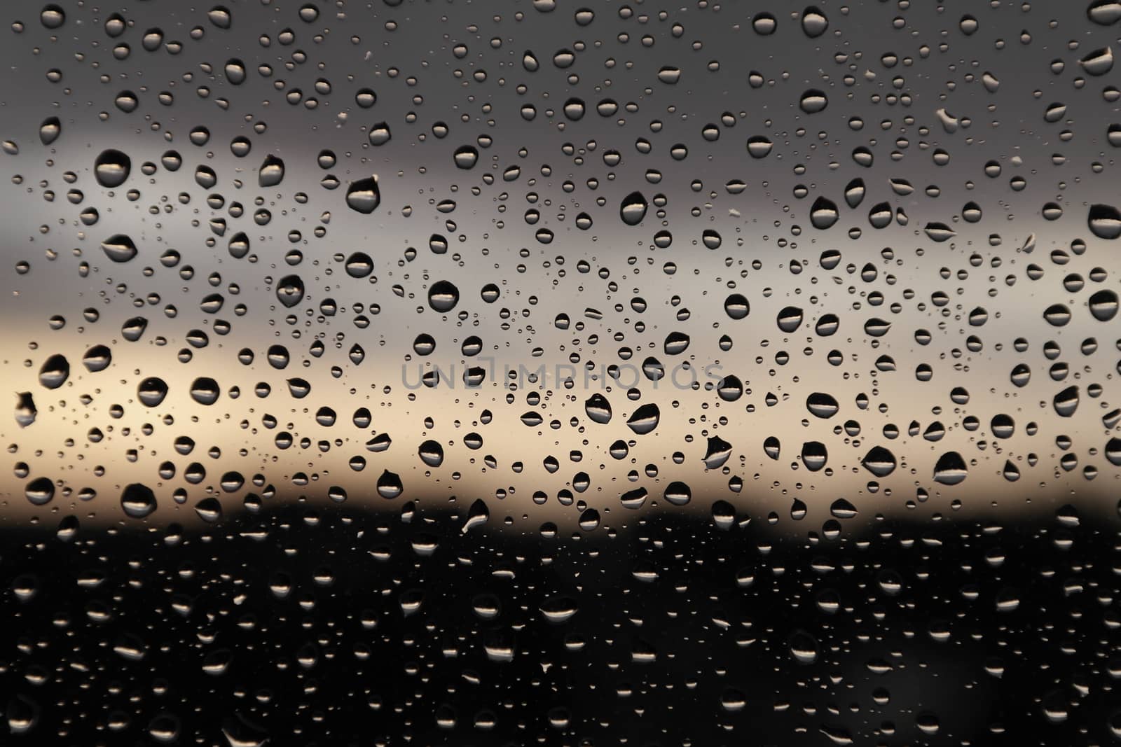 Drops of rain on the window, rainy day. Shallow DOF