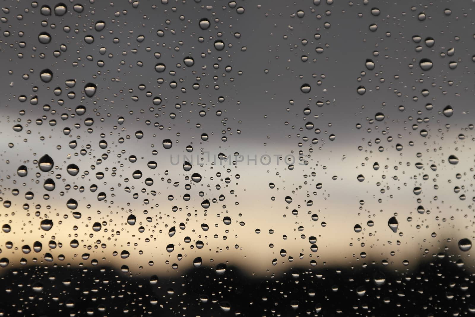 Drops of rain on the window, rainy day. Shallow DOF