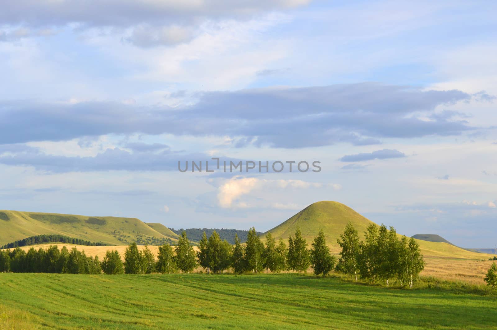 summer landscape with mountain and blue sky with clouds