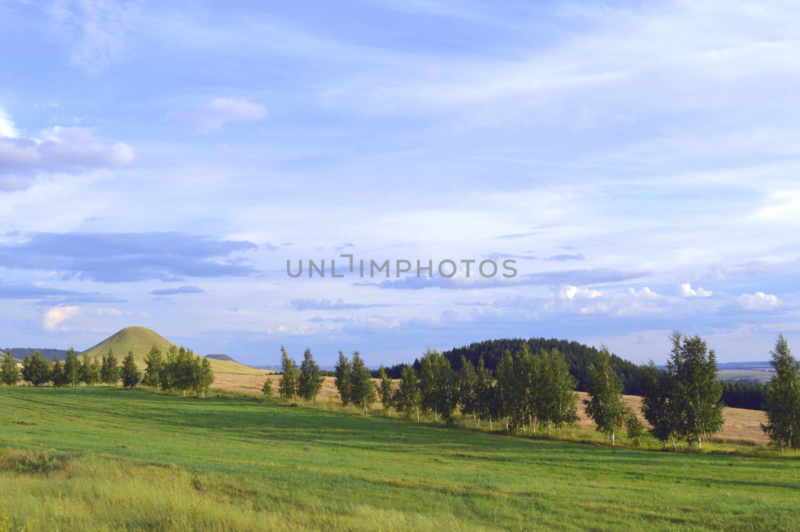 summer landscape with mountain and blue sky with clouds