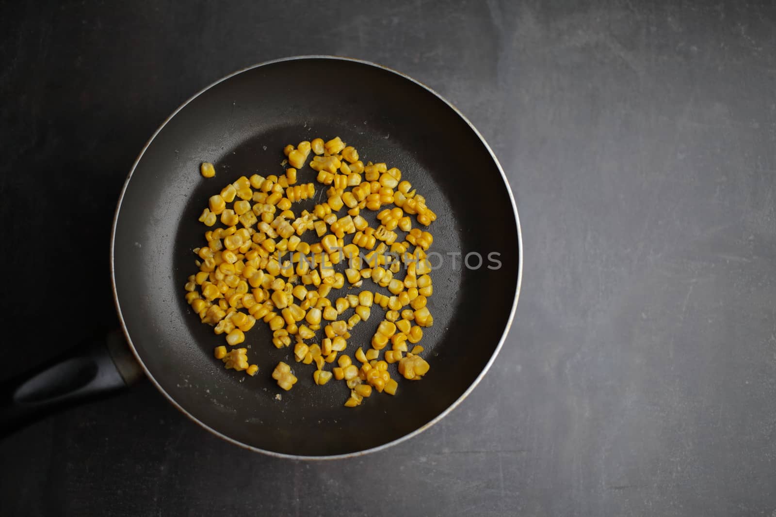 Diet. Organic Grilled Corn in a frying pan. Organic farm vegetables. Gray background Top view. Vegetarian food. Environmentally friendly products
