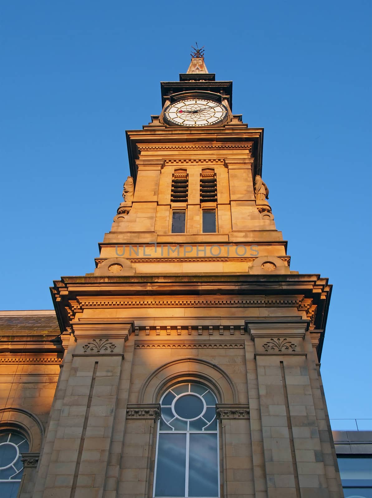 the clock tower of the historic victorian atkinson building in southport merseyside against a blue summer sky