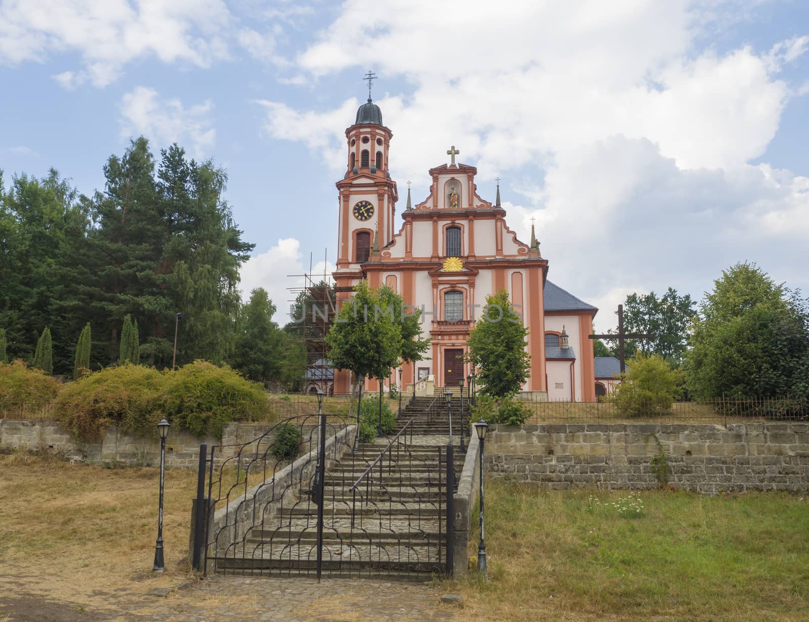 Pink and white baroque church of saint Mary Magdalene in Marenice, Czech Republic, sunny summer day, vibrant colors