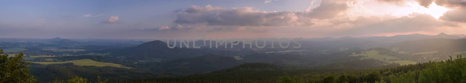 Lusatian Mountains (luzicke hory) wide panorama, panoramic view from Hochwald (Hvozd) mountain on czech german borders with blue green hills forest and pink cloudy sunset sky background