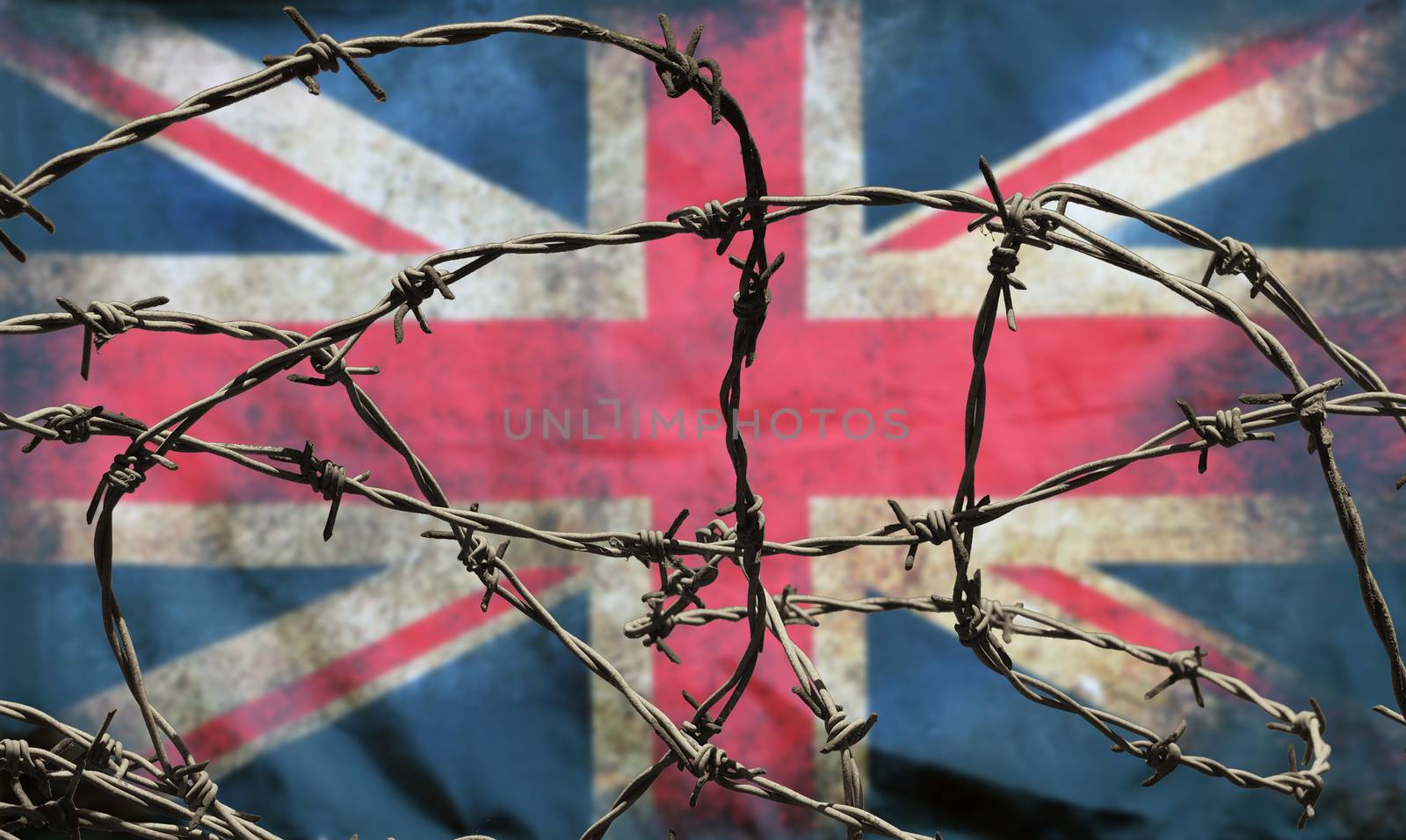 barbed wire in front of an old stained dirty union jack british flag with dark crumpled edges brexit freedom of movement isolationist concept