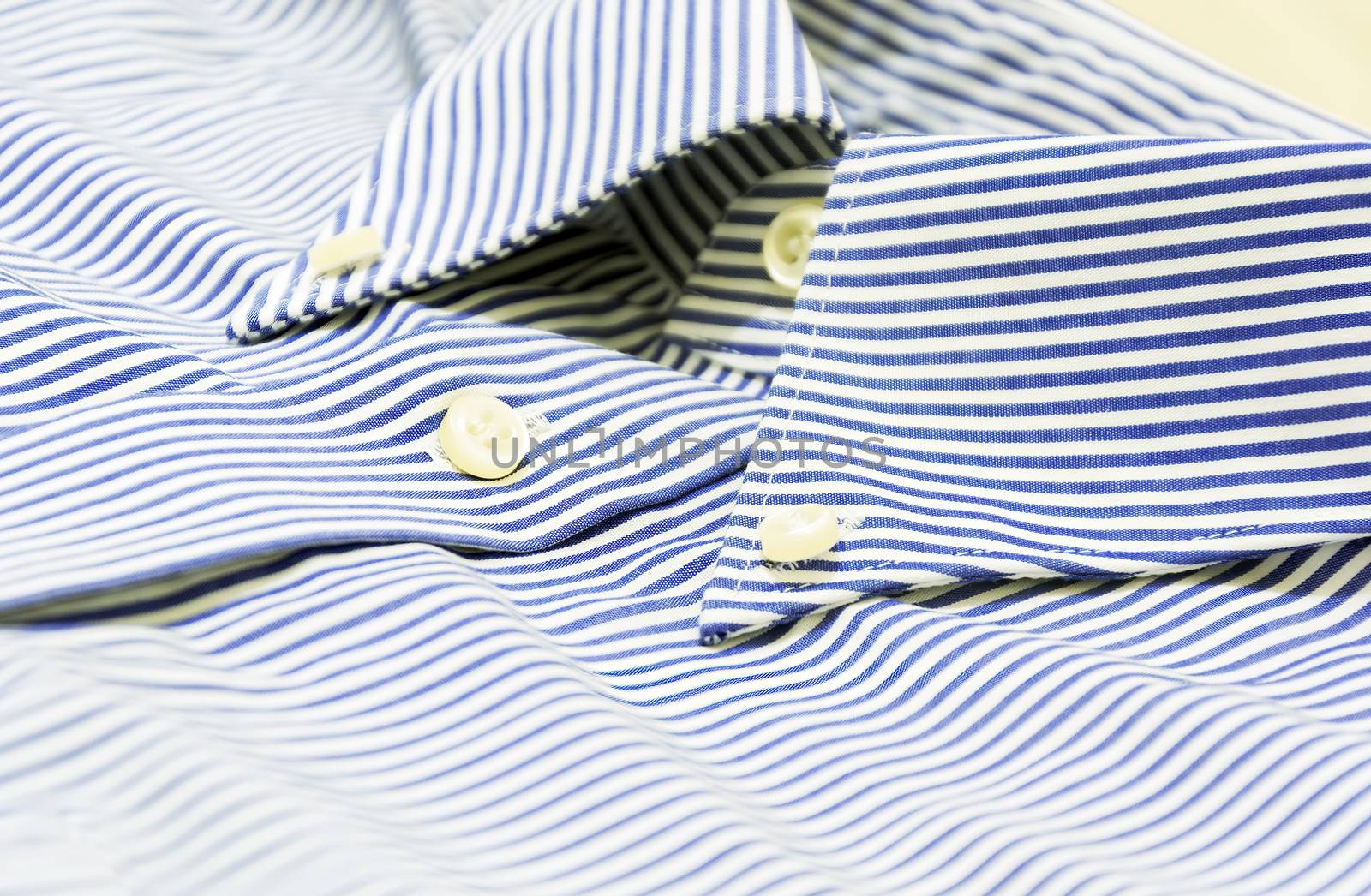 A blue striped shirt with a button down collar. Formal wear for events or work and business meetings