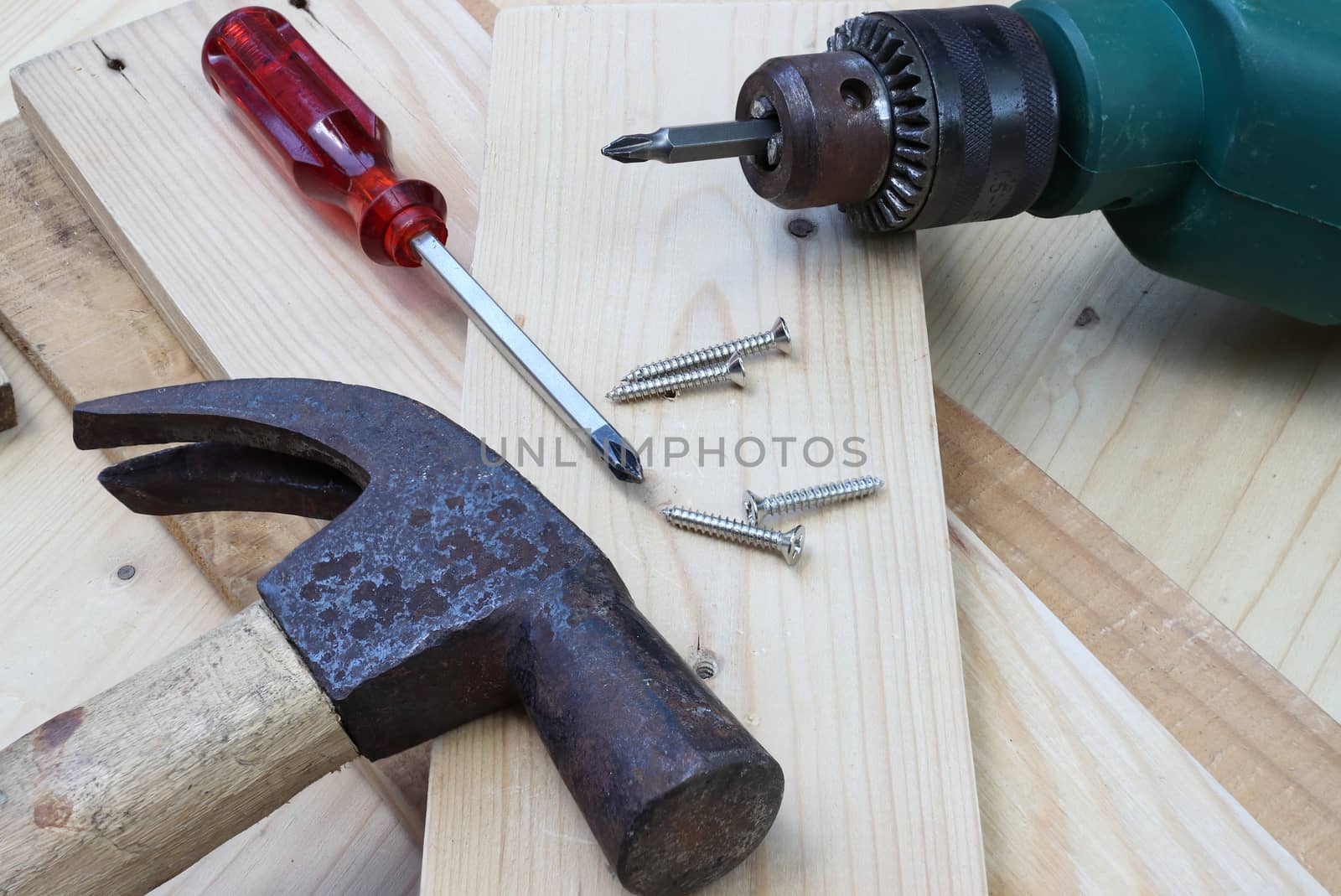 screwdriver nut and hammer on wood too for construction craft 