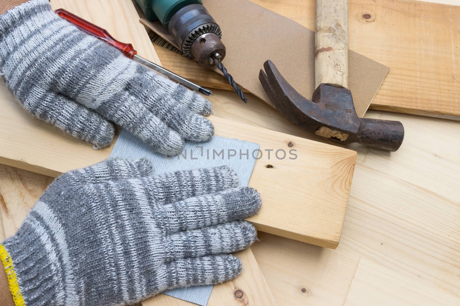 Worker Man Polishing Sandpaper Wood by hand.
