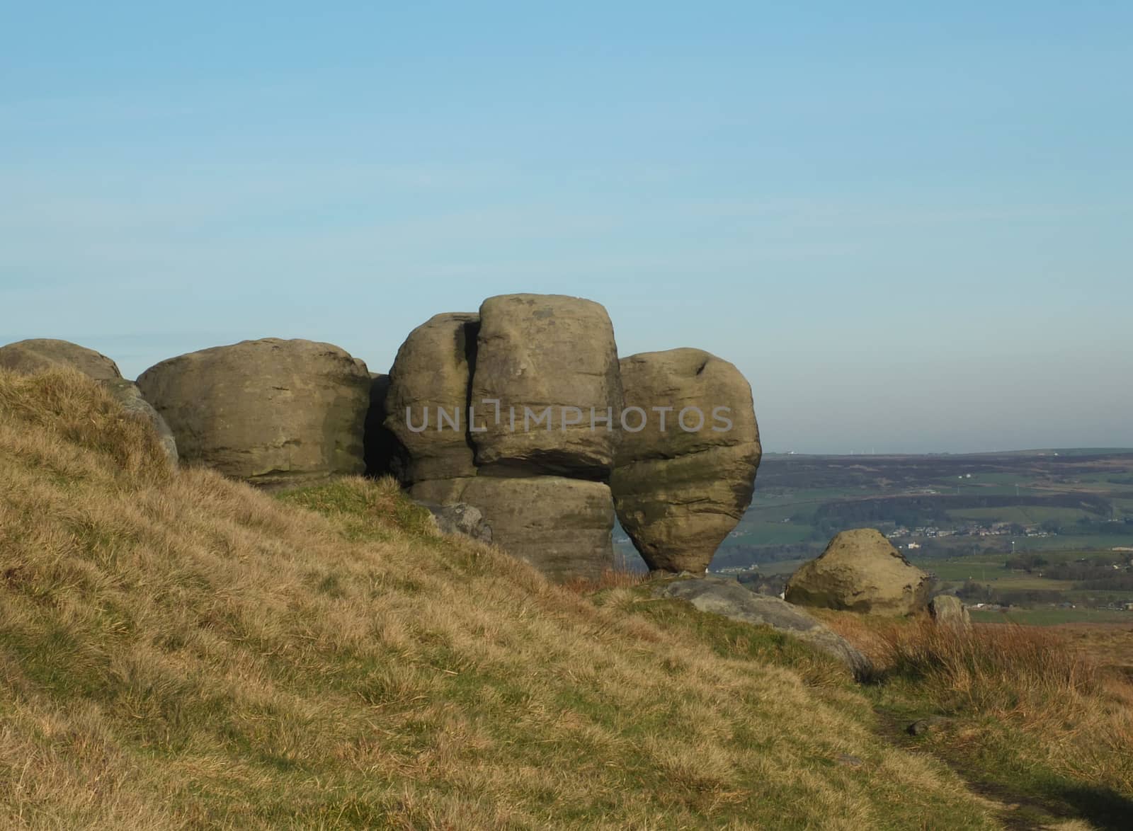 the bridestones a large group of gritstone rock formations in west yorkshire landscape near todmorden against pennine countryside