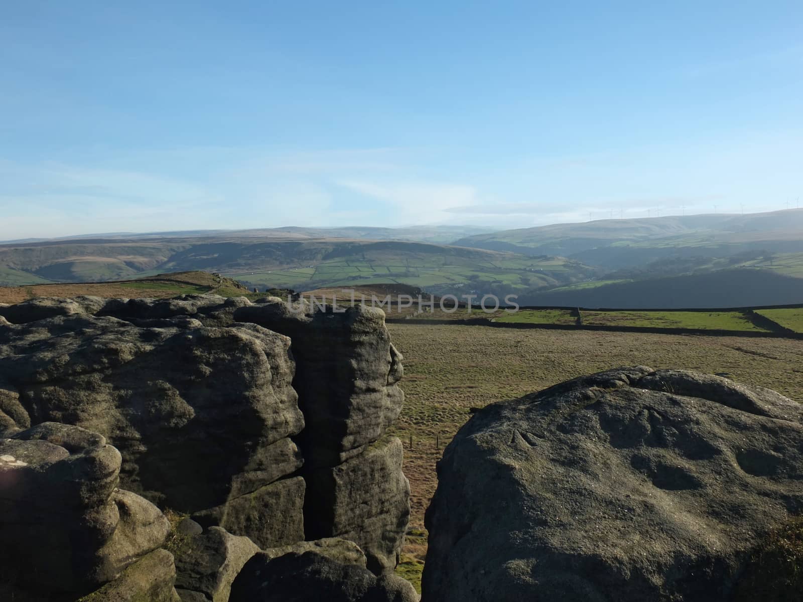 exposed rocks and boulders on bridestones moor in west yorkshire in sunlight and shadow