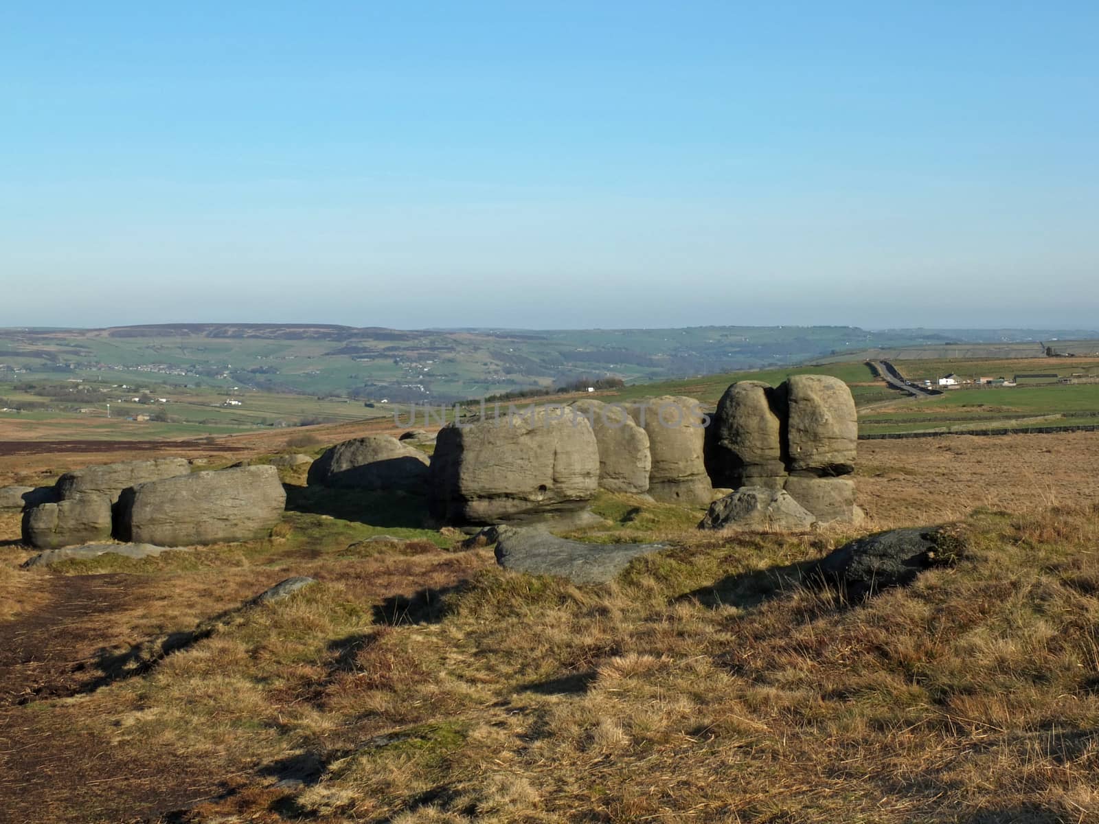 rock formations in bridestones moor in west yorkshire with a panoramic view over pennine countryside