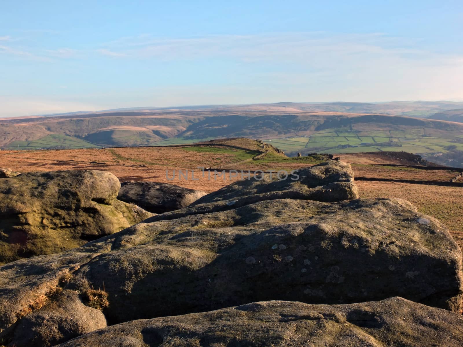 exposed rocks and boulders on bridestones moor in west yorkshire in sunlight and shadow