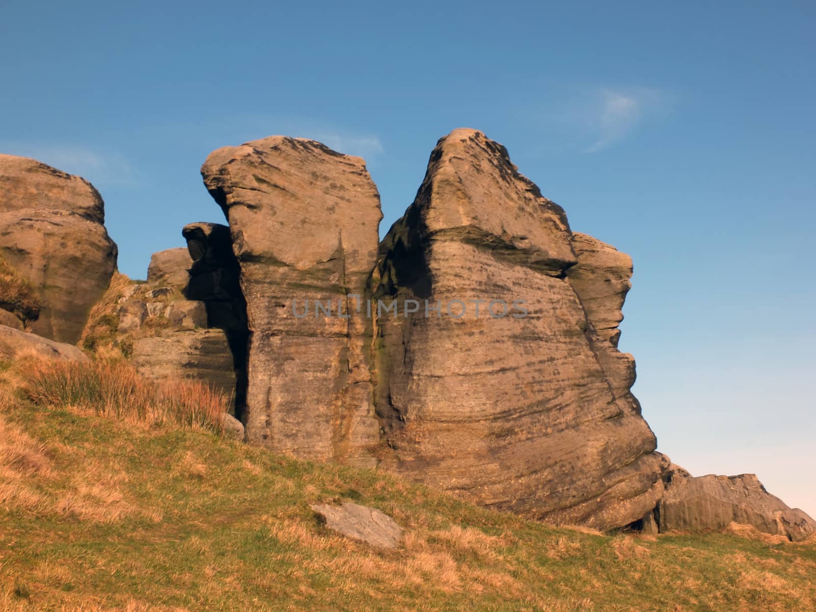 large rugged gritstone outcrop at the bridestones a large rock formation in west yorkshire near todmordenwith blue sky and surrounding countryside