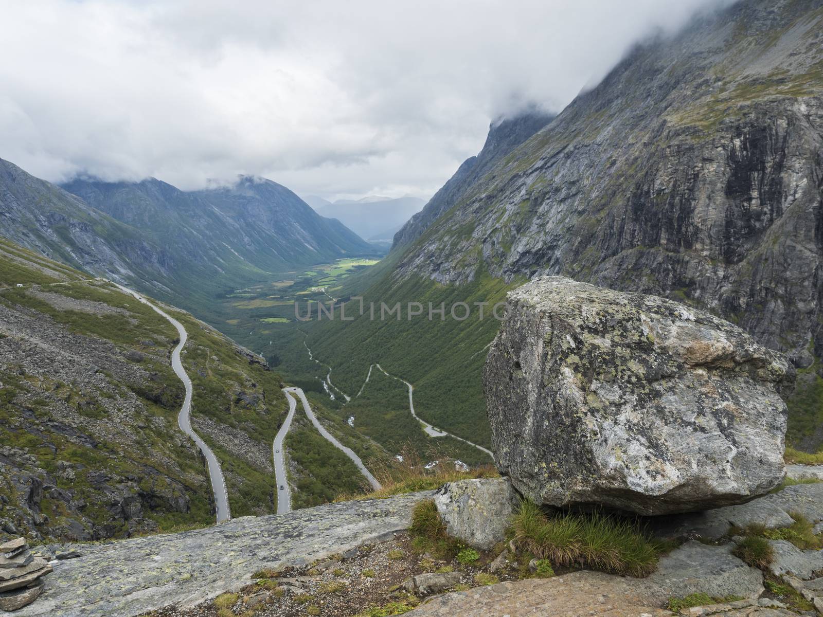 View from viewpoint platform on Trollstigen or Trolls Path, Trollstigveien famous serpentine mountain road pass and green valley on national scenic route Geiranger Trollstigen, Norway.