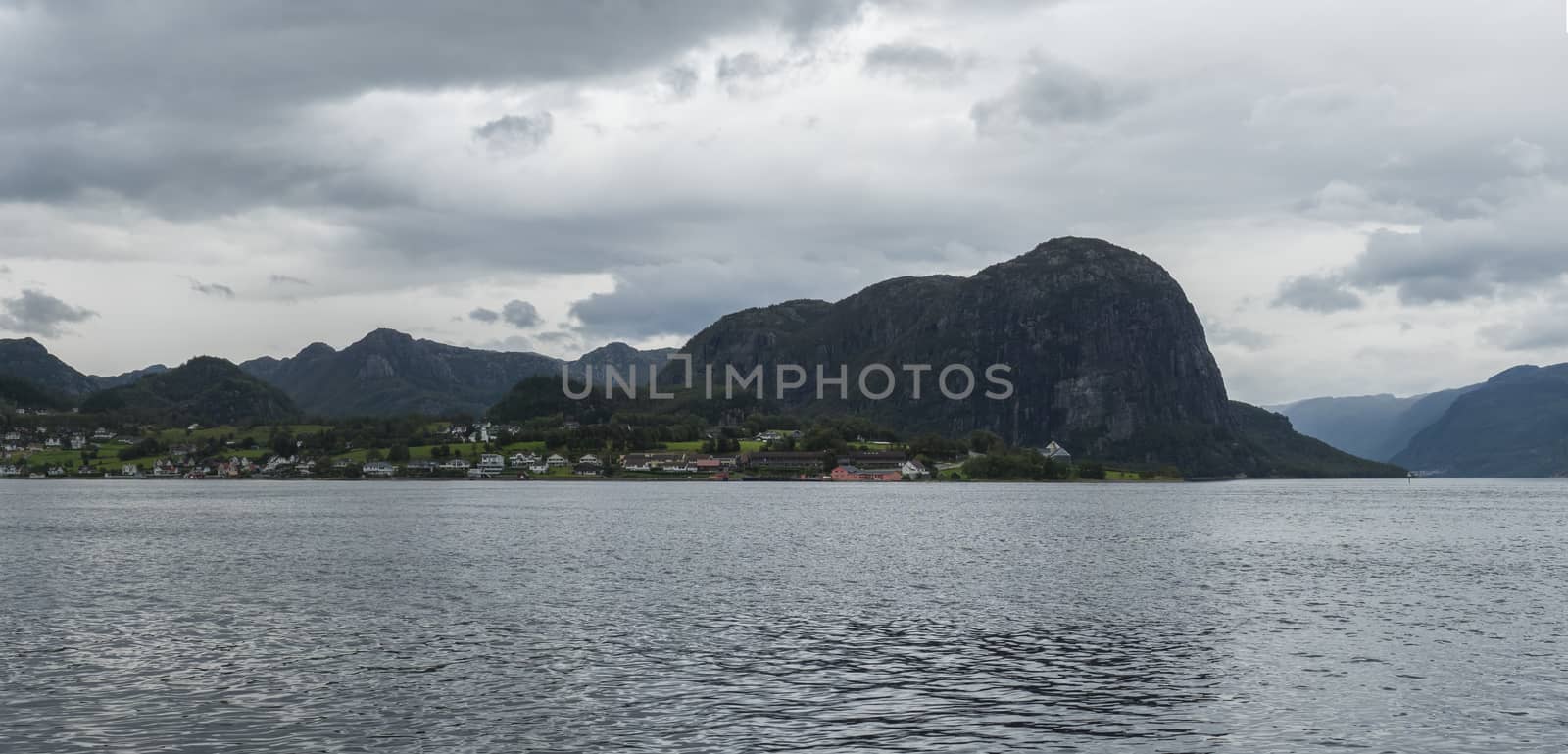 Beautiful Wide panoramic view on Norwegian fjord. View across Hogsfjorden, towards village to Lauvvik. Early autumn moody sky. Norway by Henkeova