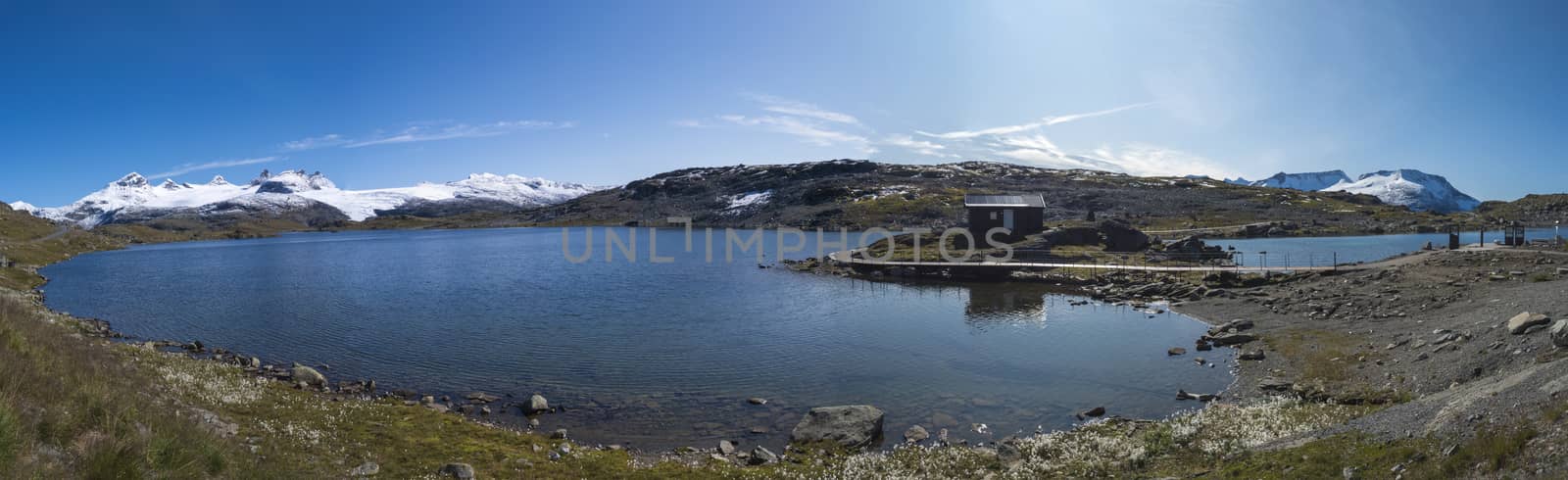 Wide panoramatic view from Sognefjellshytta with blue glacier Fantesteinsvatnet lake along National scenic route Sognefjellet between Skjolden in Western Norway. Autumn blue sky. by Henkeova