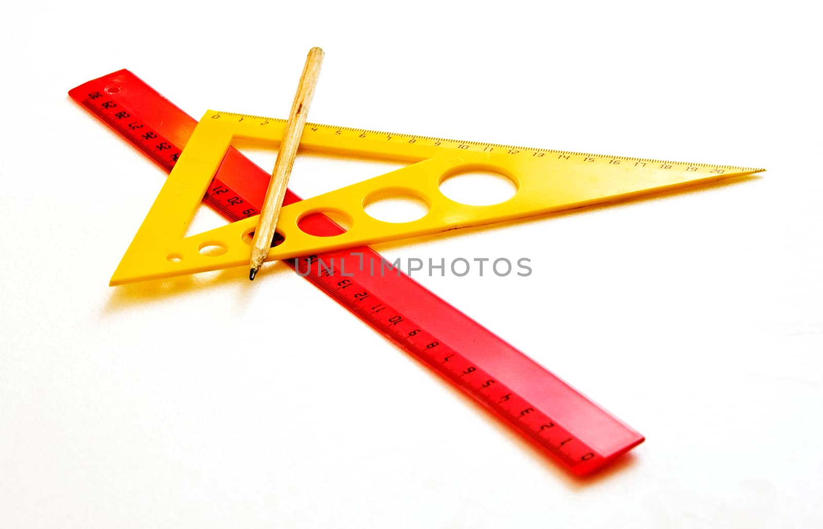 Ruler, pencil triangle on a white background by Grommik