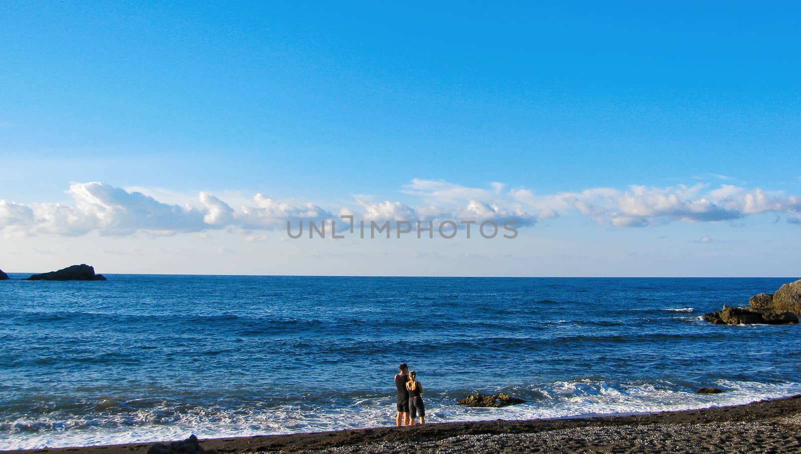 A man and a woman on the beach near the sea