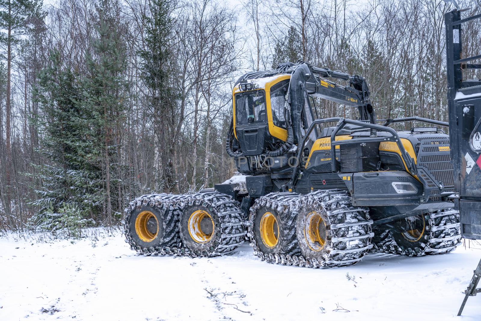 Umea, Sweden NOVEMBER 10, 2019: High performance modern forestry machine for forest cutting, stacking and logging, delivering peak efficiency and productivity for specific forestry tasks. Winter by skydreamliner