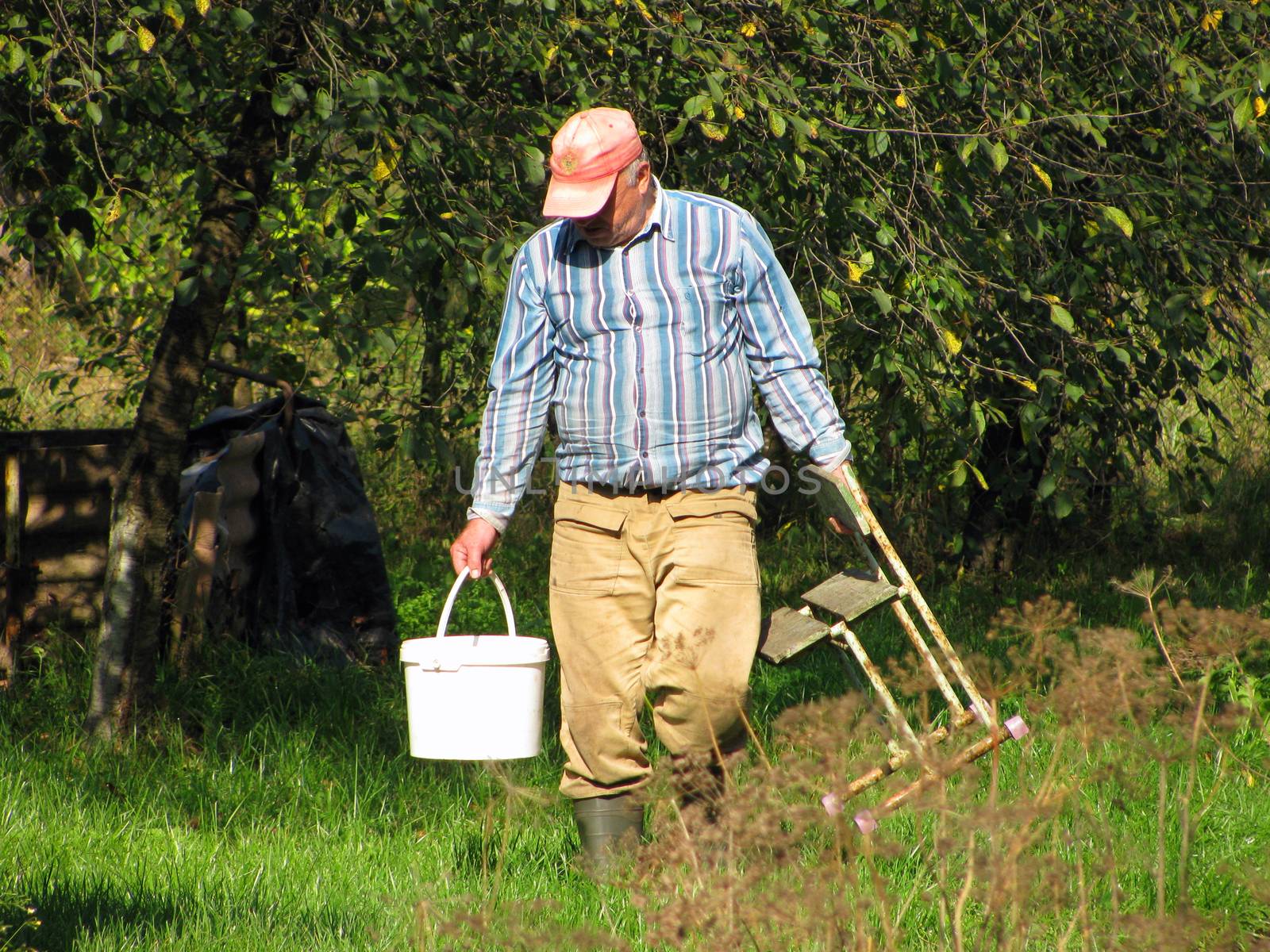 Farmer man at work on the site by Grommik