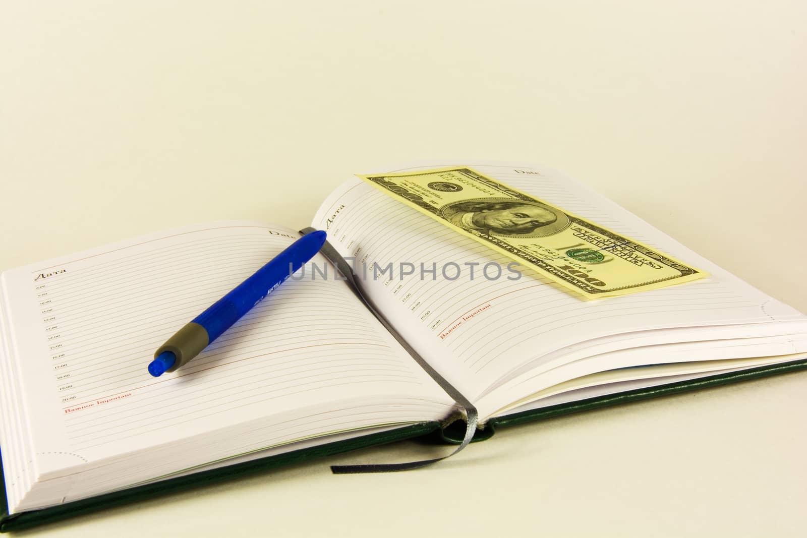 Book for planning and banknote of 100 dollars 