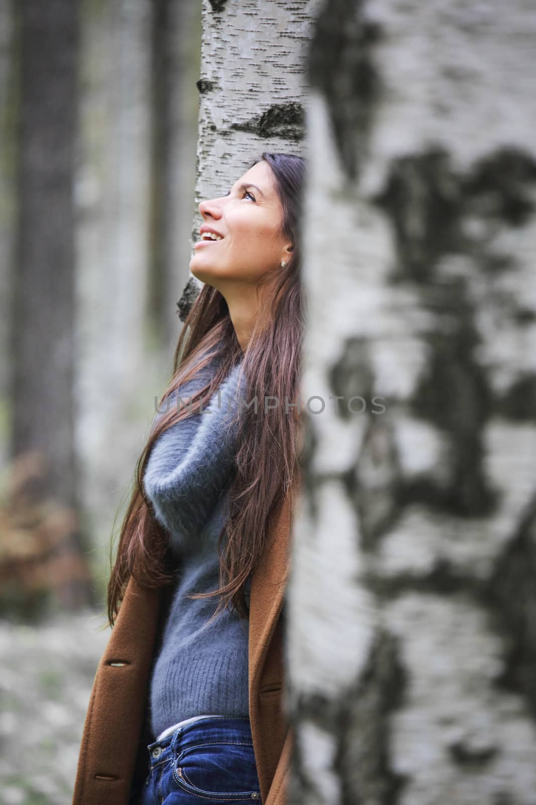 Happy woman in autumn park by destillat