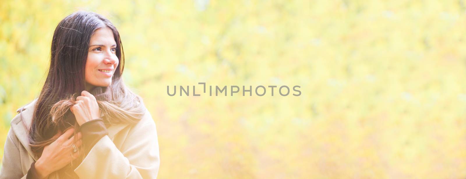 Portrait of young brunette cute woman smiling walking in autumn park