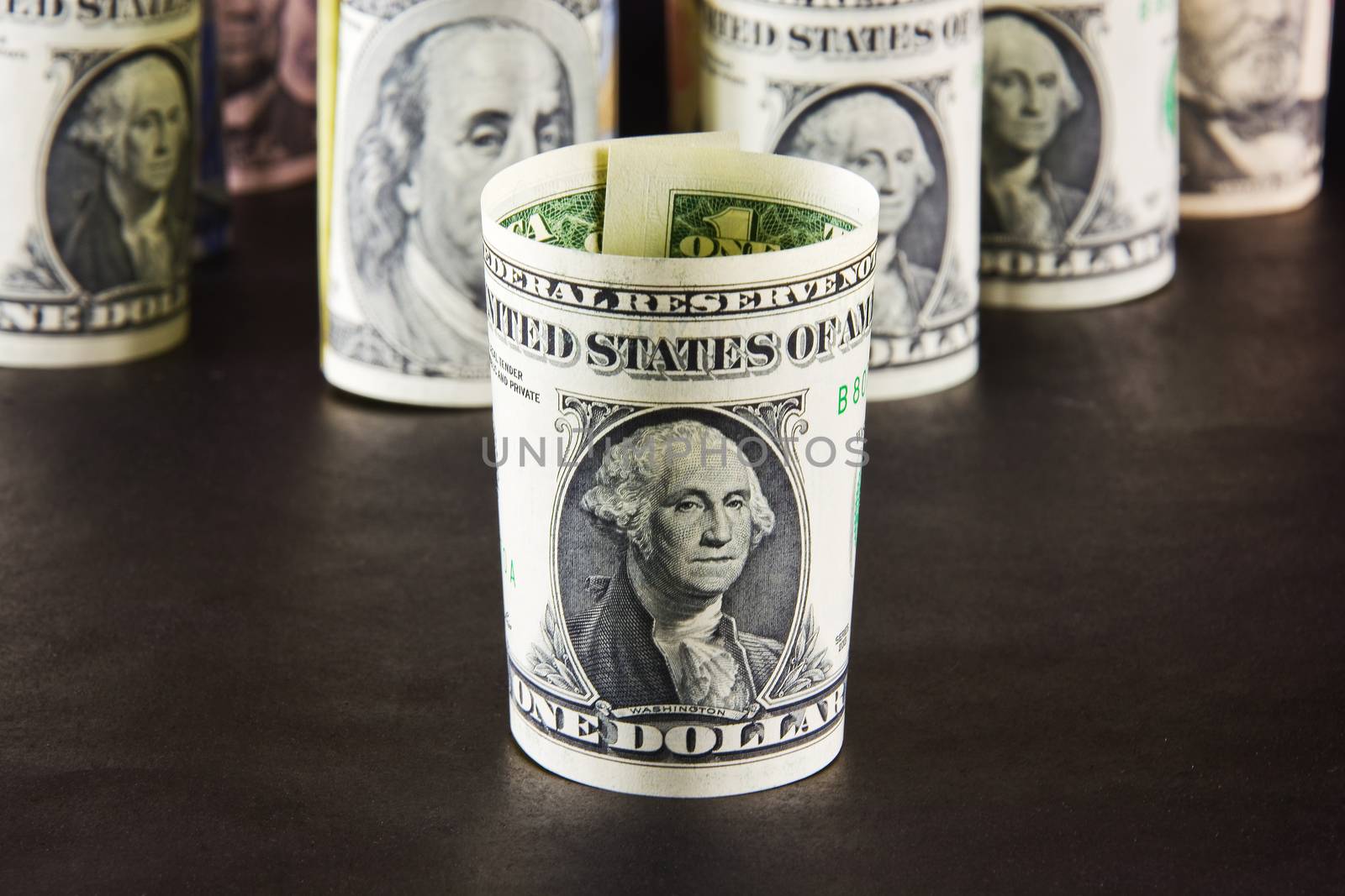 President with one dollar banknotes on a background of presidents from other denominations