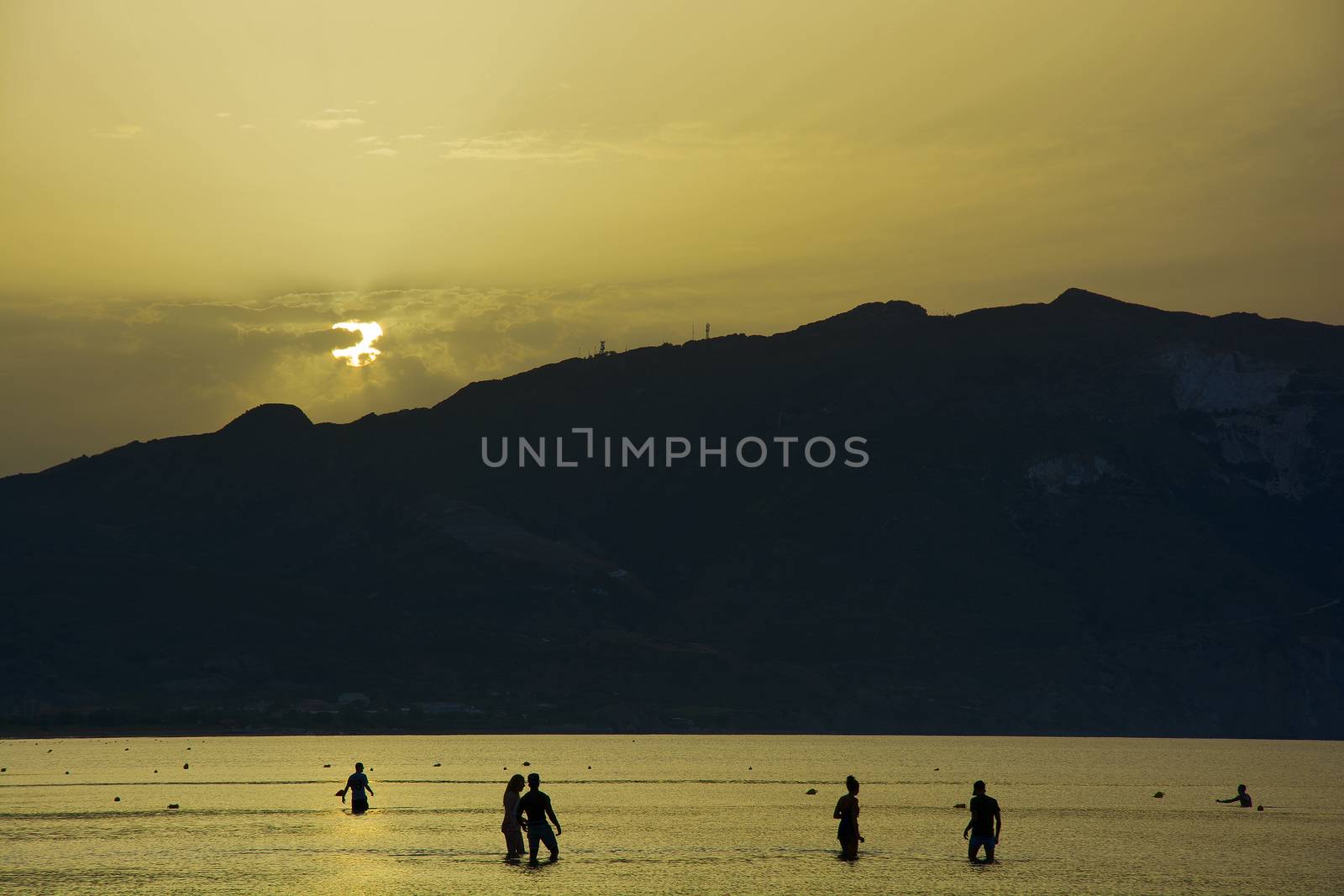 People bathe in the sea at sunrise by Grommik