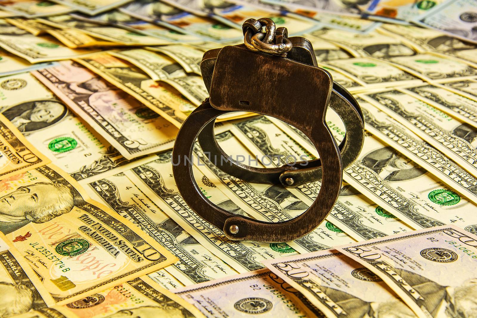 Denominations dollars of various face value and handcuffs placed by Grommik