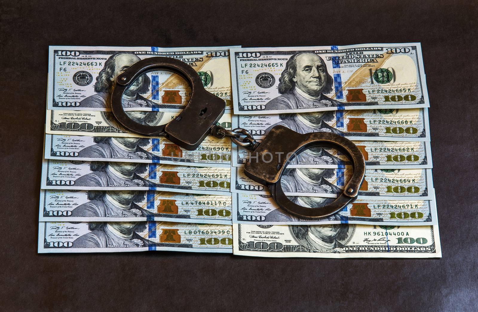 The handcuffs are on banknotes hundred dollars



