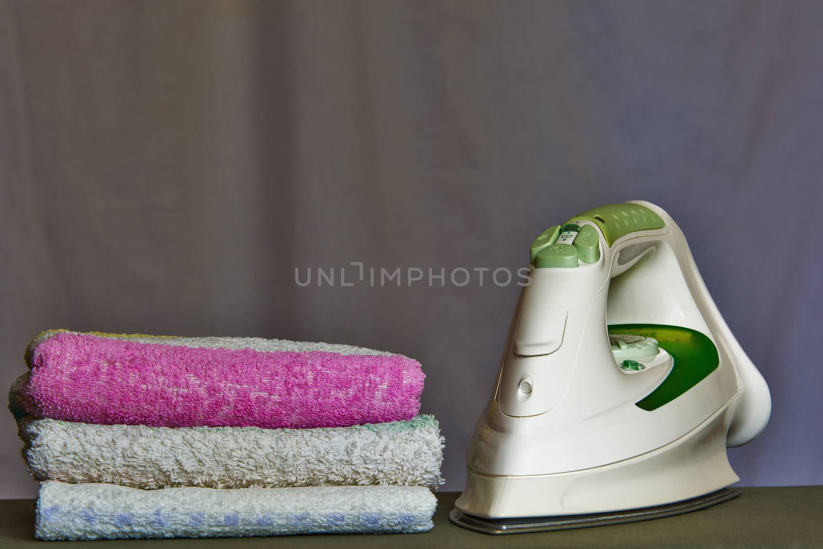 A stack of towels is about iron by Grommik