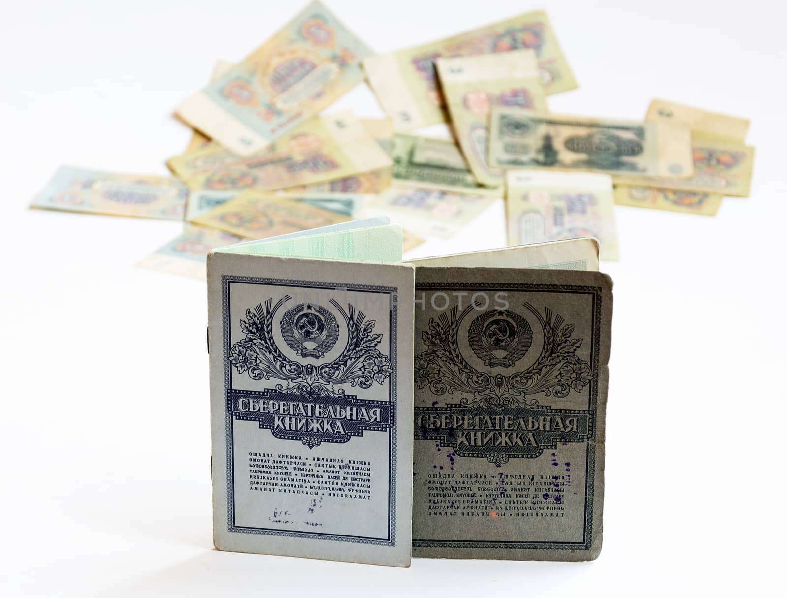 Savings books of the Soviet Union, are standing upright. In the background is seen the Soviet rubles without harshness
