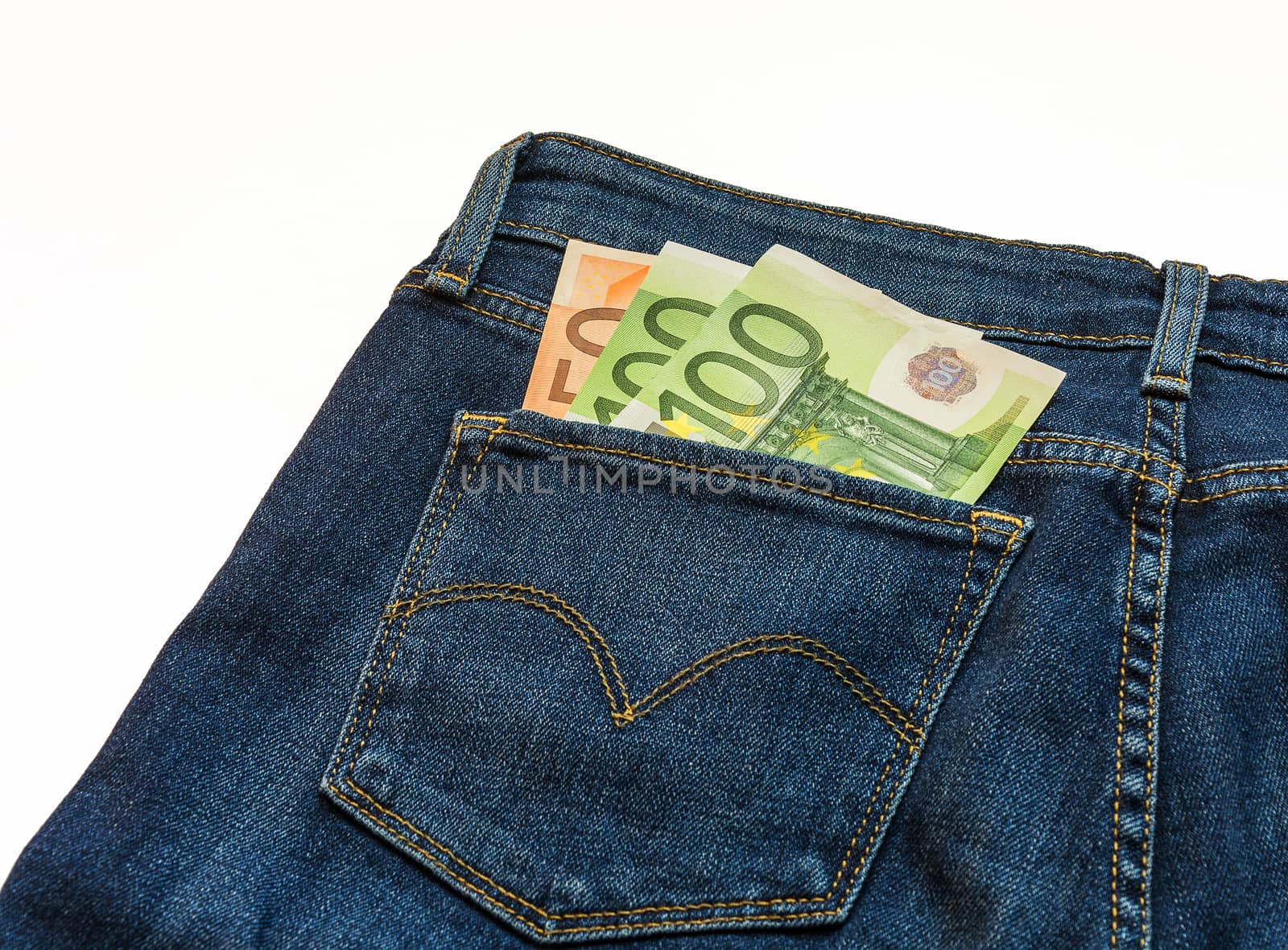 In the back pocket of blue jeans pants is three banknotes one hundred and fifty euros