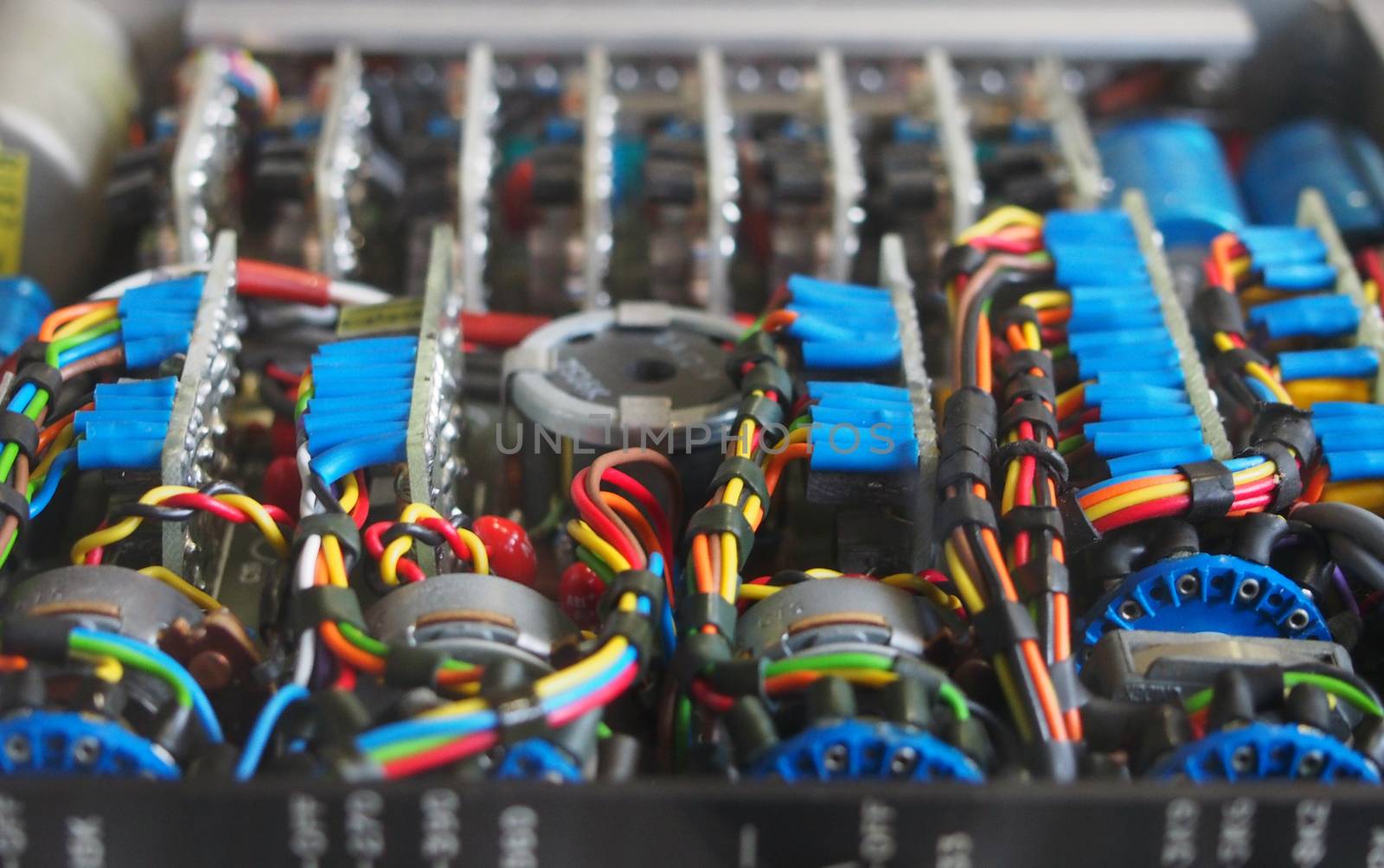 selective focus image of complex colored wiring and connectors joining circuit boards with electrical components