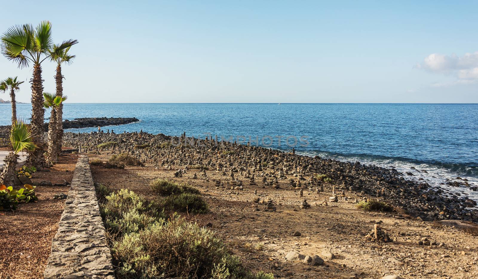 Cairn on the shore of the island Tenerefe in La Caleta area by Grommik