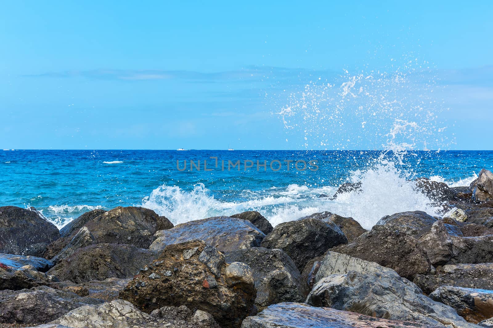 Splashes of water breaking on coastal rocks