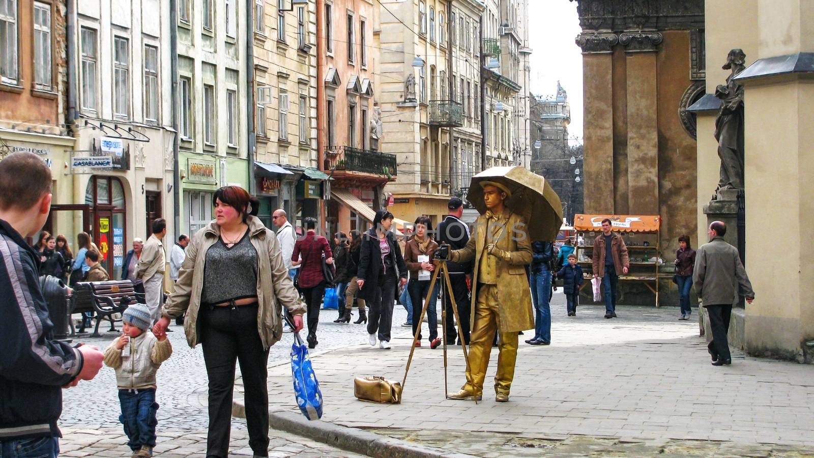 Tourists in the streets and people still figure depicts a Photog by Grommik