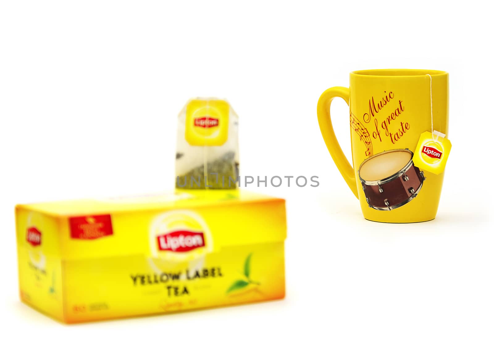 Yellow mug and tea bag packing with Lipton by Grommik