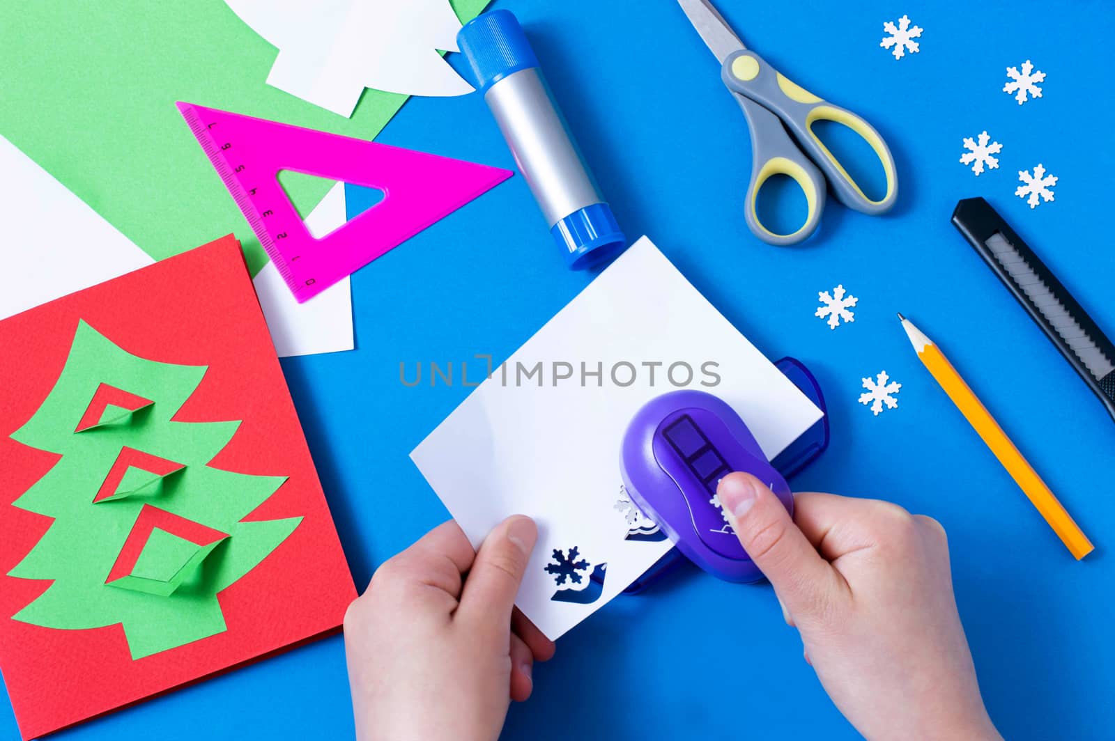 Child makes card with Christmas tree. Original children's art project. DIY concept. Step-by-step photo instructions. Step 8. Cut snowflakes