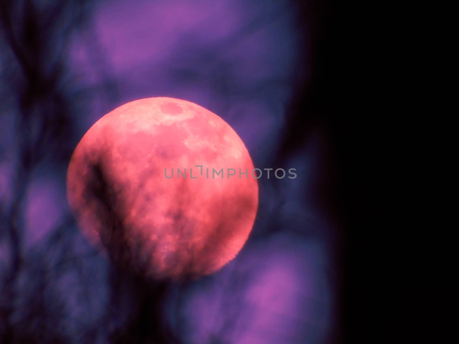 Liguria, Italy - 07/22/2020: Beautiful photography of the moonlight in the different phases with different colours. Black sky and little stars in the background.