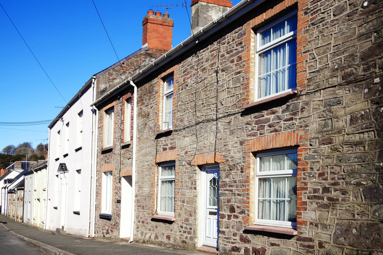 Old fashioned terraced town houses in Laugharne Carmarthenshire Wales UK stock photo