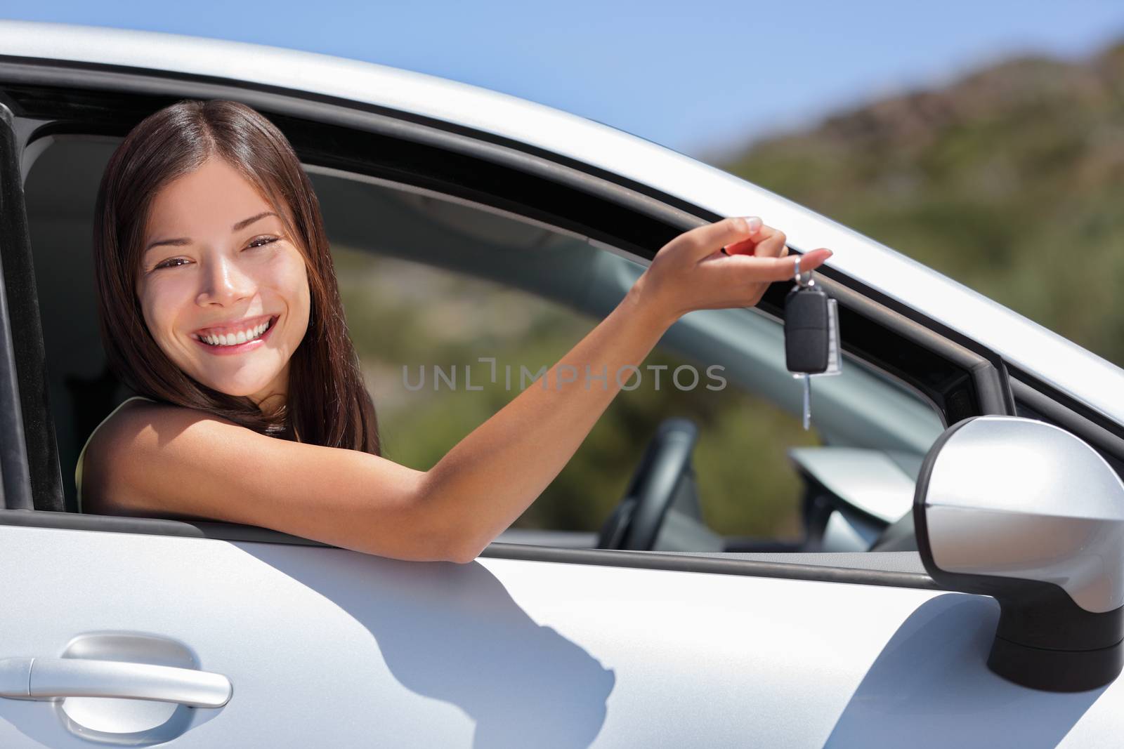 New car driver woman holding keys for travel road trip. Happy young Asian girl with rental lease or purchase of automobile at dealership by Maridav