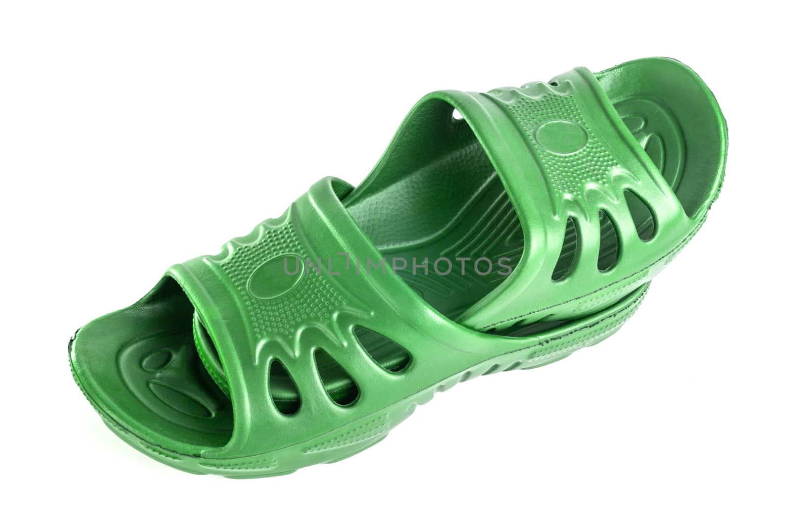 a pair of cheap durable green rubber slippers one inside other isolated on white background.