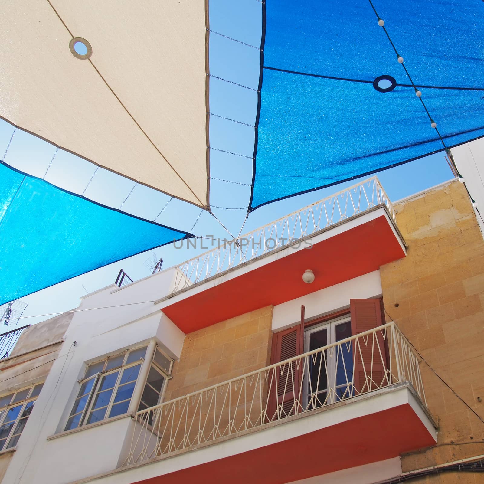 detail of a painted colourful street in the center of nicosia cyprus with blue and white shades covering the the road in bright summer sunlight by philopenshaw
