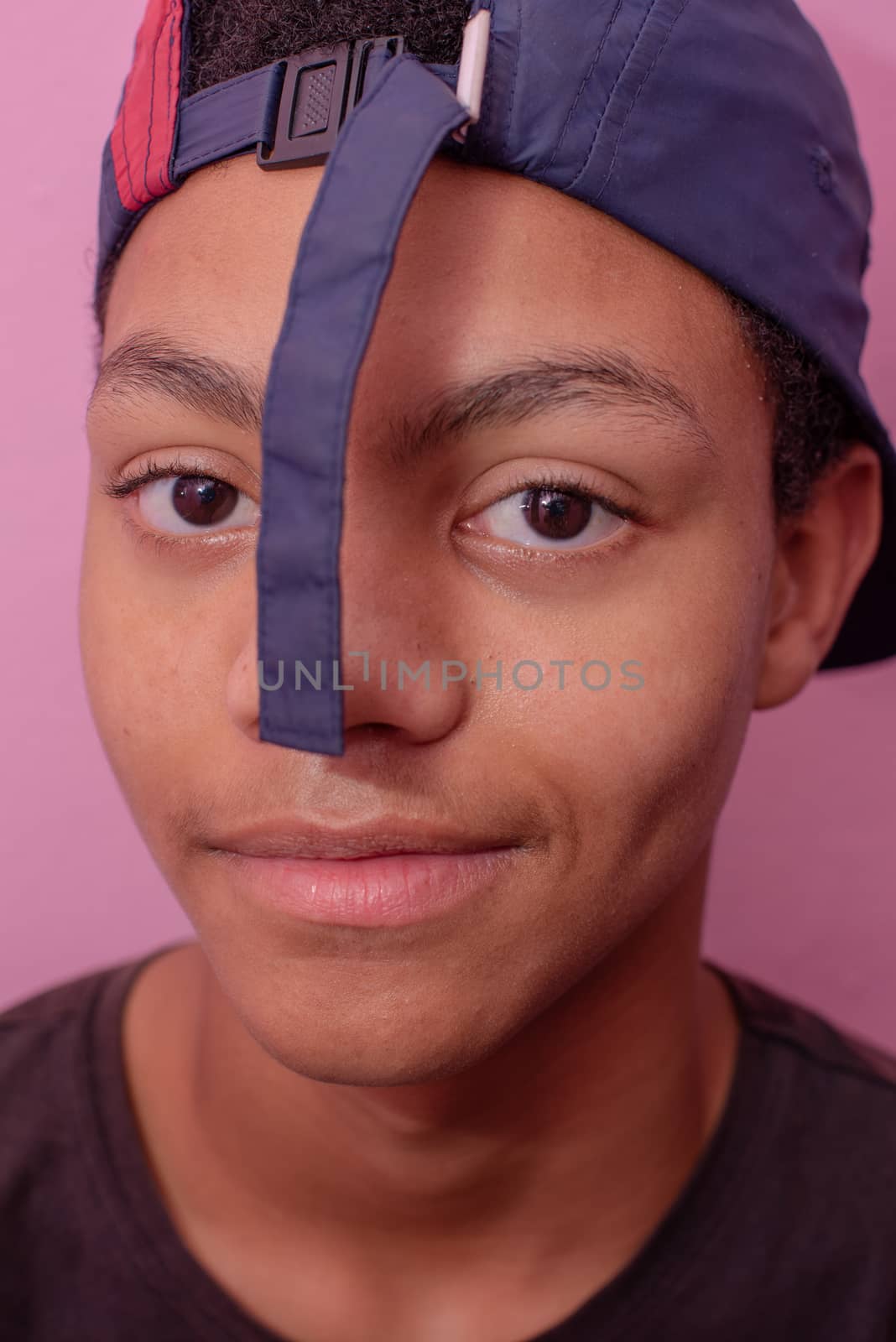 Vertical portrait of teenager with cap turned on backwards by rushay