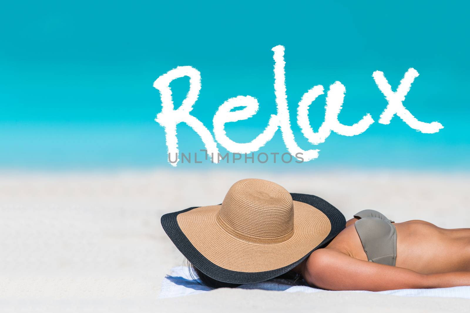 RELAX written on beach background for summer holidays concept. Word above woman tanning lying down sleeping covering her face with hat for uv sun rays protection. Vacation girl relaxing on travel.