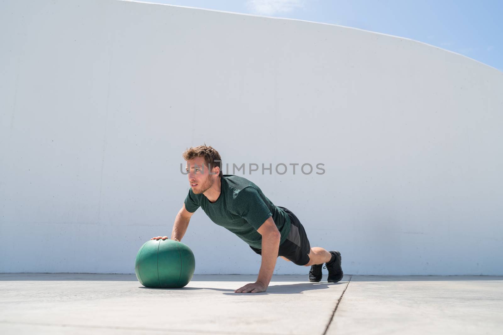 Fitness man strength training pushup medicine ball by Maridav
