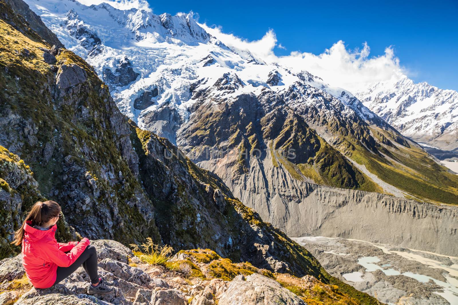 New zealand woman tourist lifestyle hiking in mountains relaxing looking at view of Mt Cook. Alps in South island by Maridav