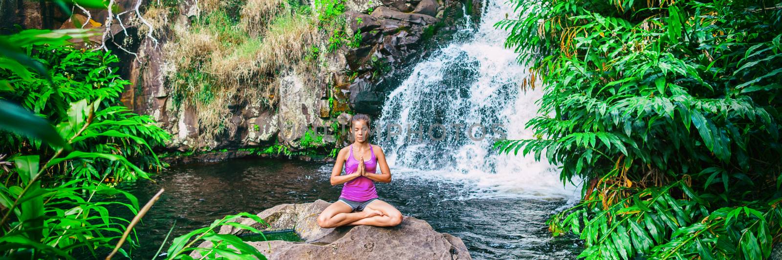 Wellness yoga woman practicing meditation in nature by watefall and lush forest. Banner panorama of health and fitness, mindfulness concept by Maridav